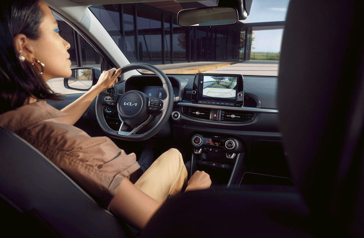 Frau sitzt im neuen Kia Picanto