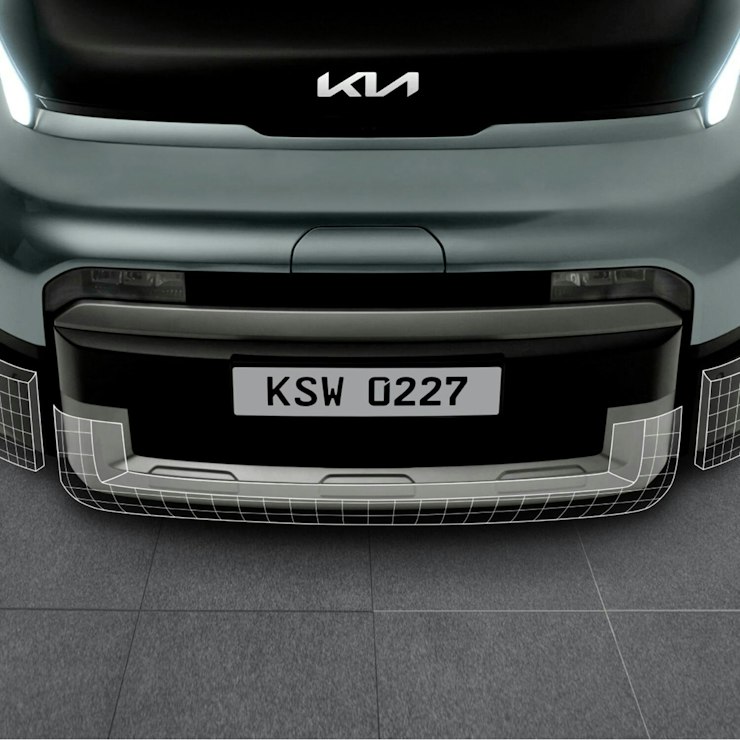 Nahaufnahme des vorderen Stossfängers und des unteren Kühlergrills des Kia PV5 WAV.